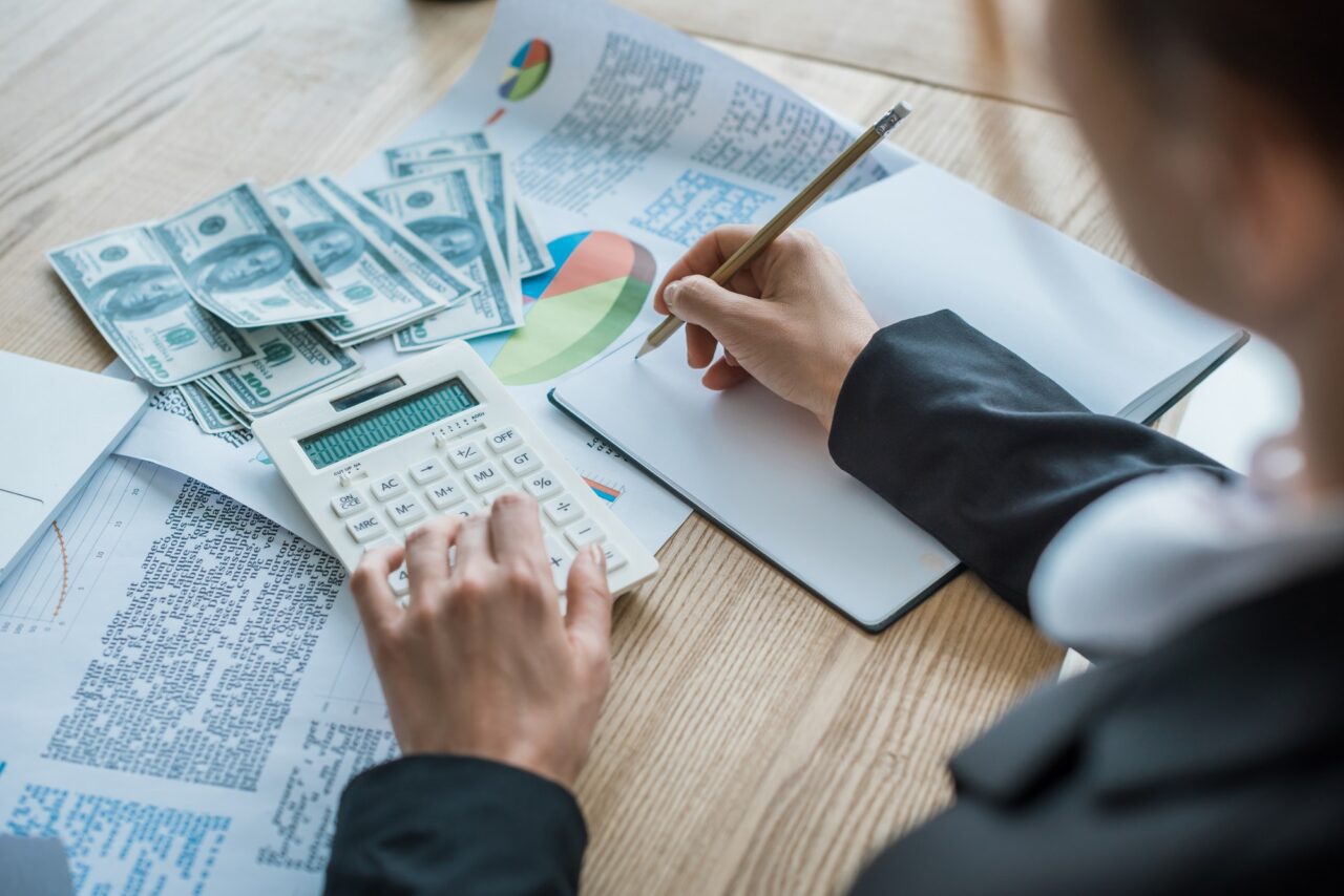 cropped image of accountant writing something to notebook in office 1